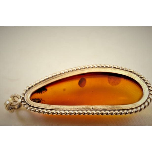FJL Jewelry Sterling Silver Pendant Experience the allure of the Baltic Sea with this exquisite pendant featuring a unique AA-grade Baltic Amber of cognac hue.