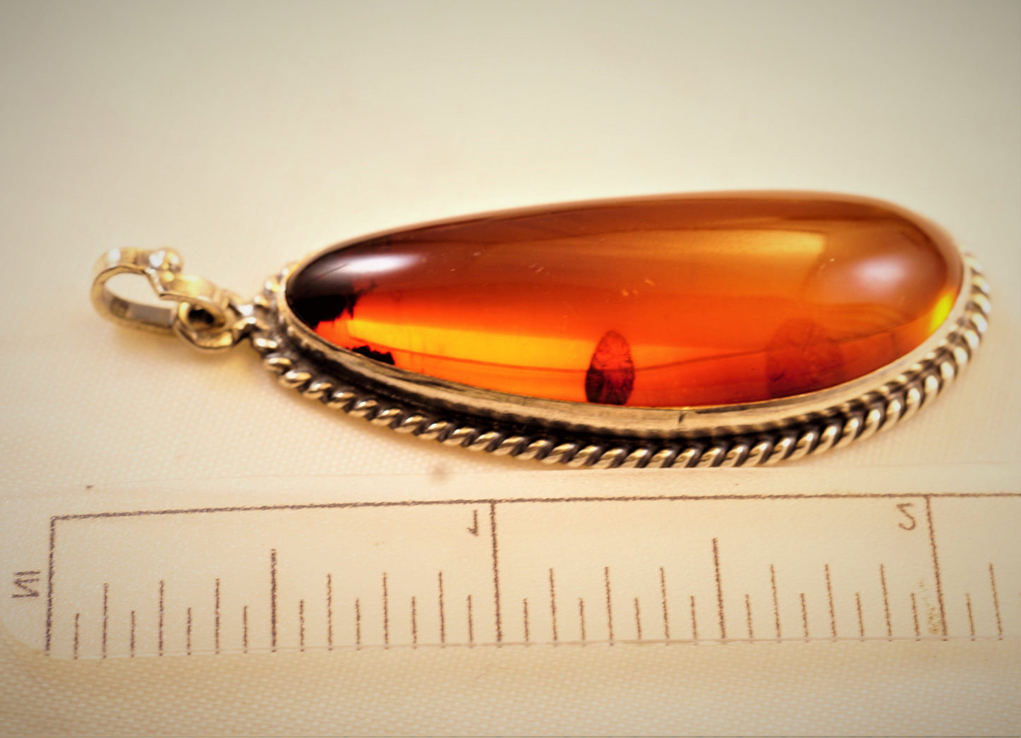 FJL Jewelry Sterling Silver Pendant Experience the allure of the Baltic Sea with this exquisite pendant featuring a unique AA-grade Baltic Amber of cognac hue.